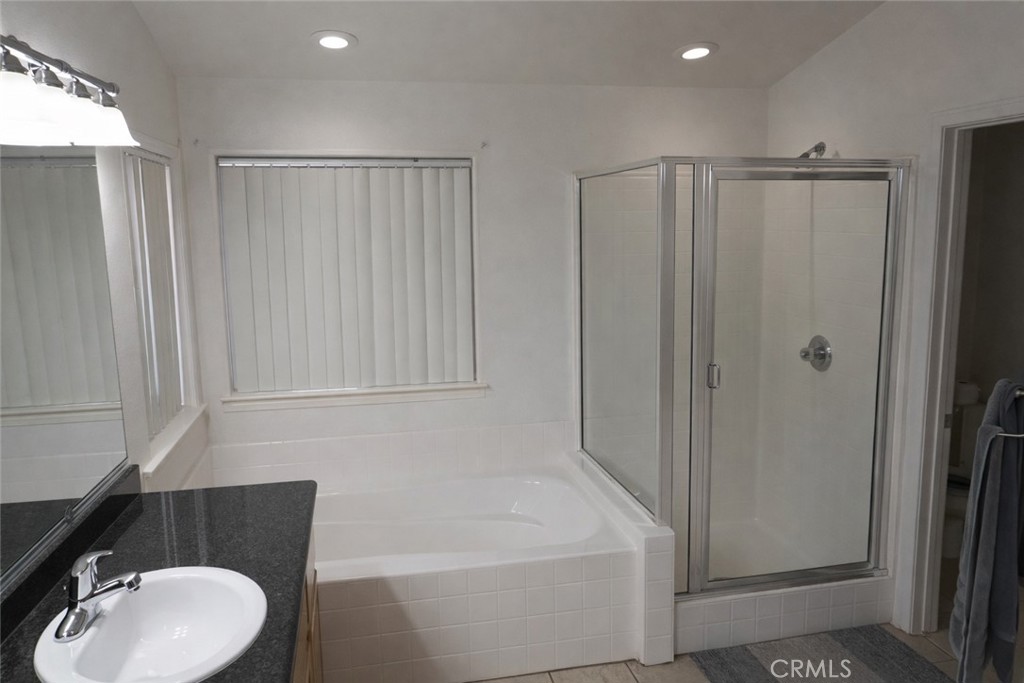 19095 Glenwood Avenue Riverside, CA 92508 - Photo 10 of 14 a bathroom with a sink a toilet and shower