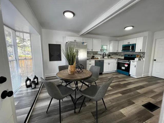 a view of a dining room with furniture window and outside view