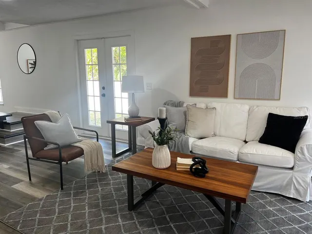 a living room with furniture and wooden floor