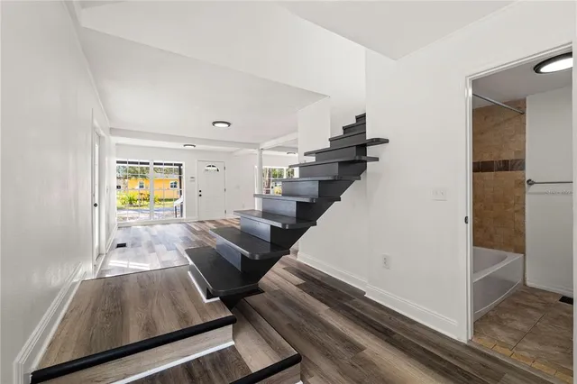 a view of living room with furniture and wooden floor