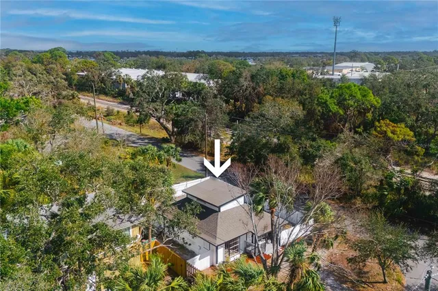 an aerial view of a house with a lake view