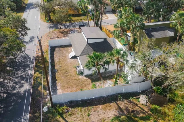 an aerial view of a house with a yard and lake view