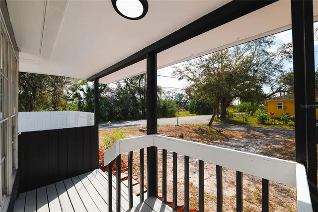 a view of balcony with wooden floor and fence