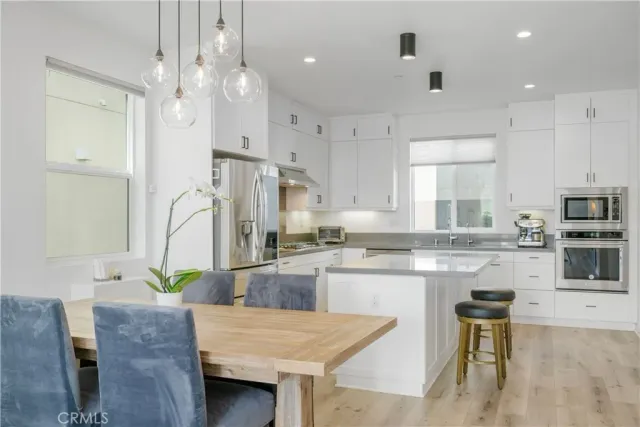 a kitchen with stainless steel appliances granite countertop a stove refrigerator and cabinets