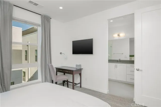 a bedroom with a bed and a flat screen tv