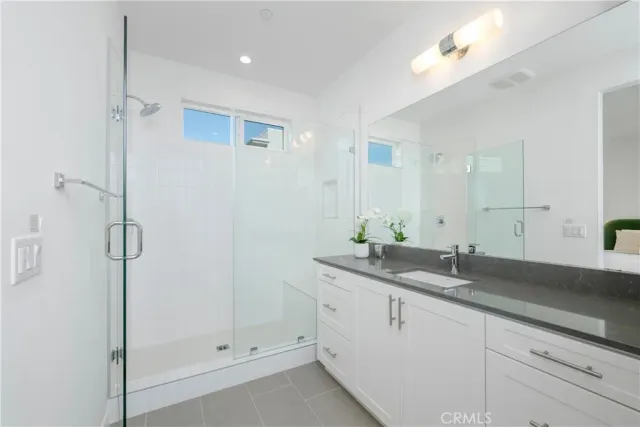 a bathroom with a granite countertop sink mirror and double