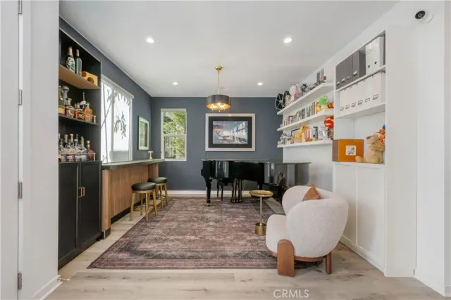 a living room with furniture and paintings on the wall