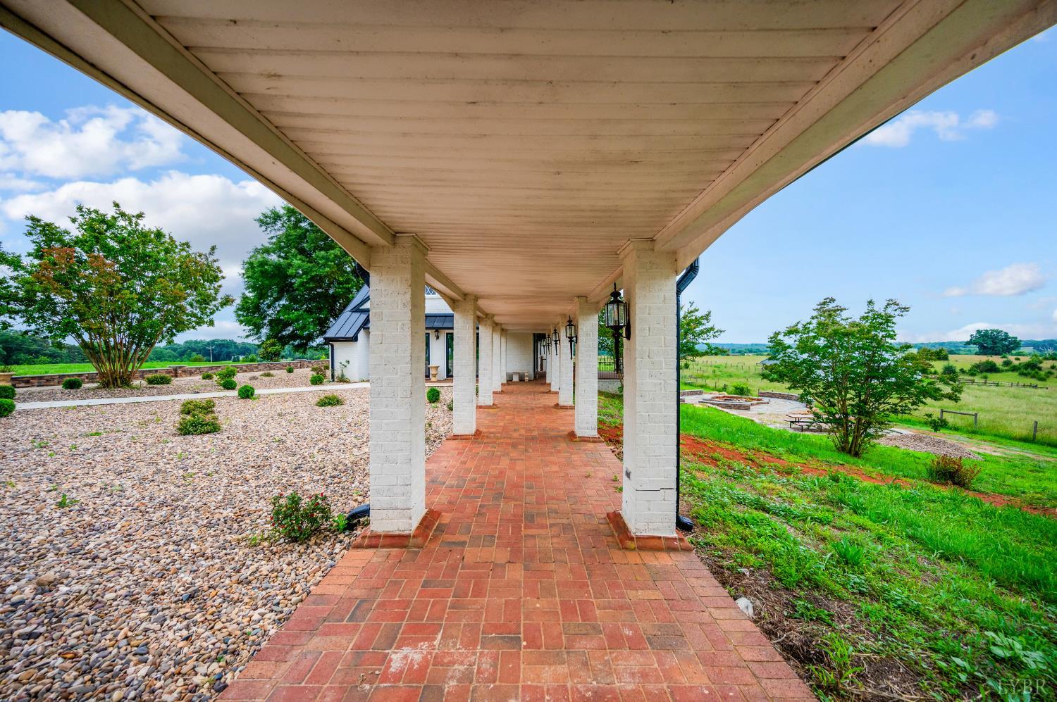 7845 Bear Creek Road Gladys, VA 24554 - Photo 17 of 99 a view of a patio with table and chairs potted plants with wooden floor