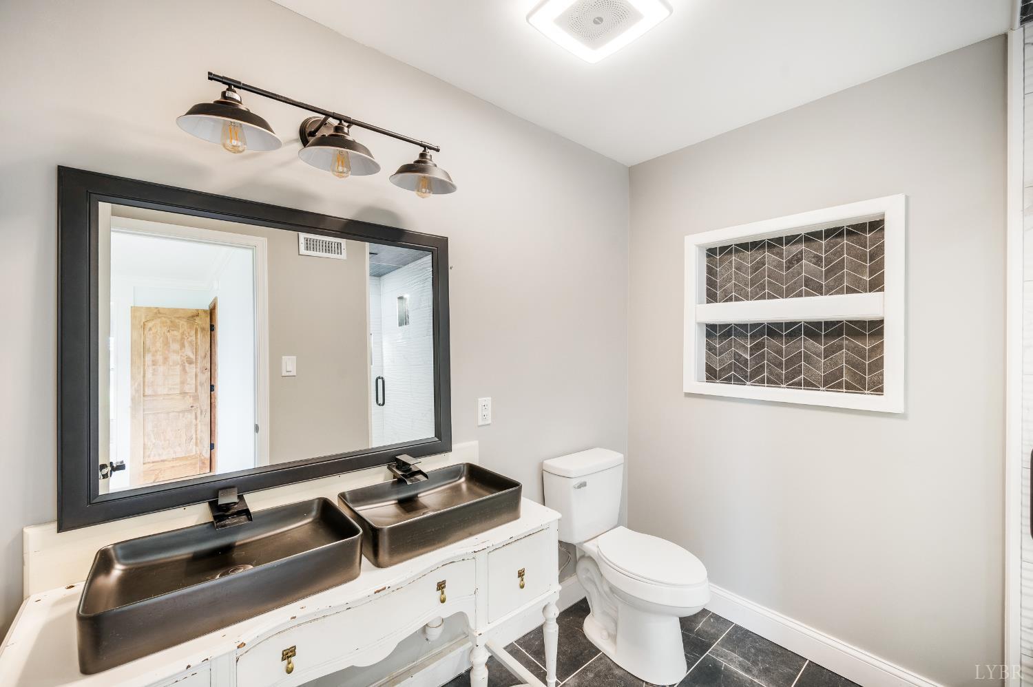 7845 Bear Creek Road Gladys, VA 24554 - Photo 54 of 99 a bathroom with a sink toilet and mirror
