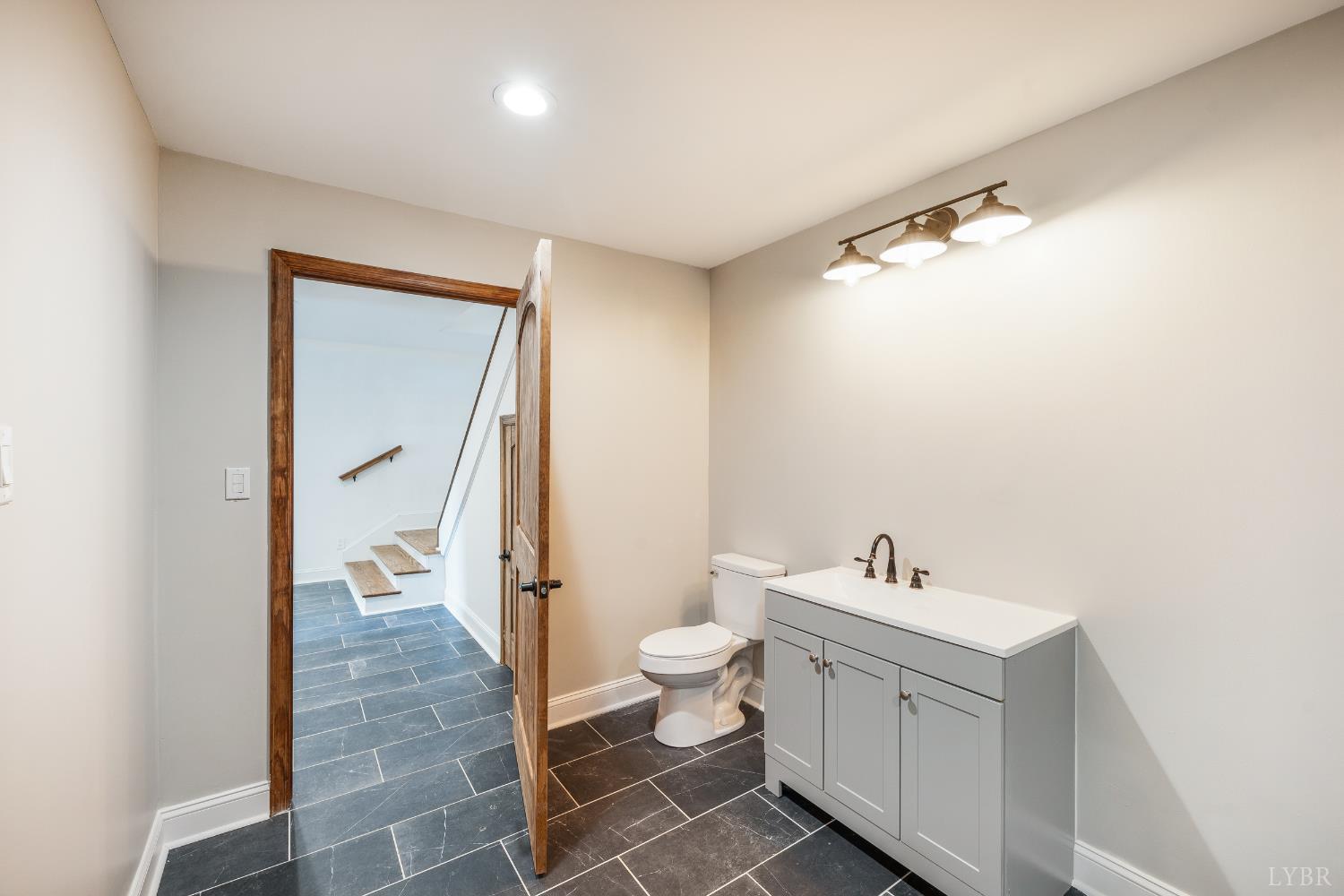 7845 Bear Creek Road Gladys, VA 24554 - Photo 76 of 99 a bathroom with a sink and mirror with toilet