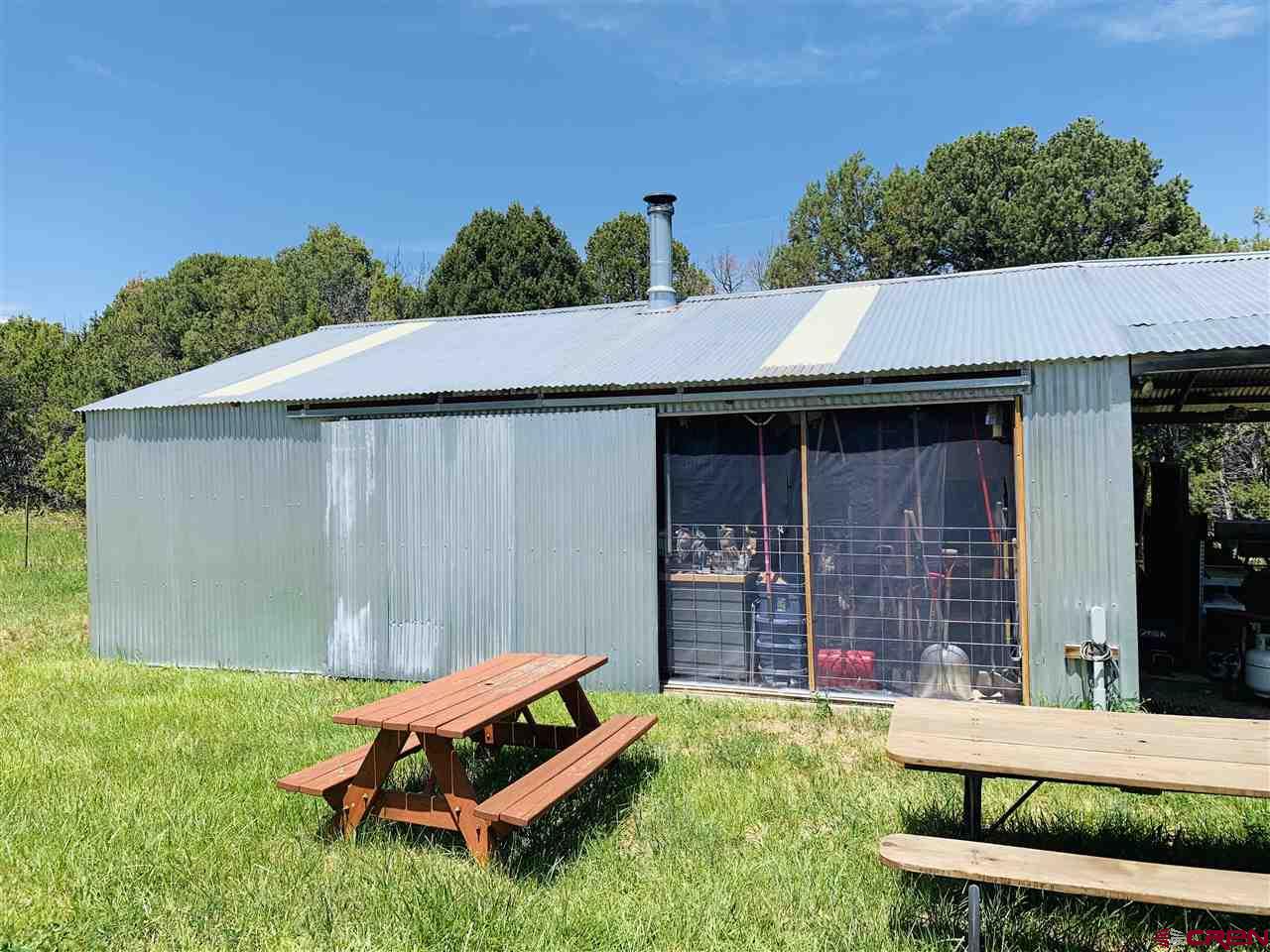 678 3375th Road Crawford, CO 81415 - Photo 12 of 42 a backyard of a house with table and chairs