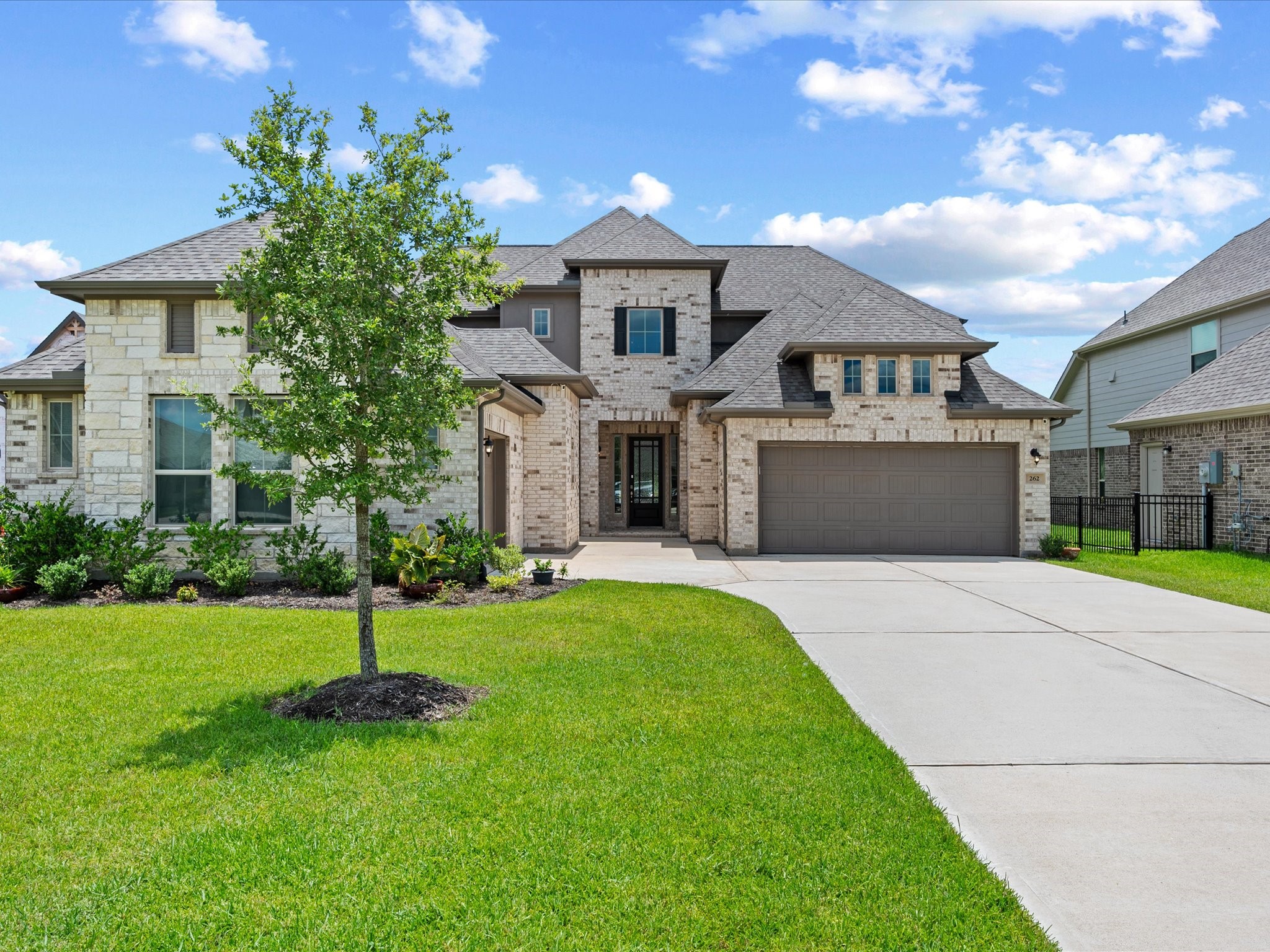 262 Peninsula Point Drive Montgomery, TX 77356 - Photo 1 of 45 a front view of a house with a garden