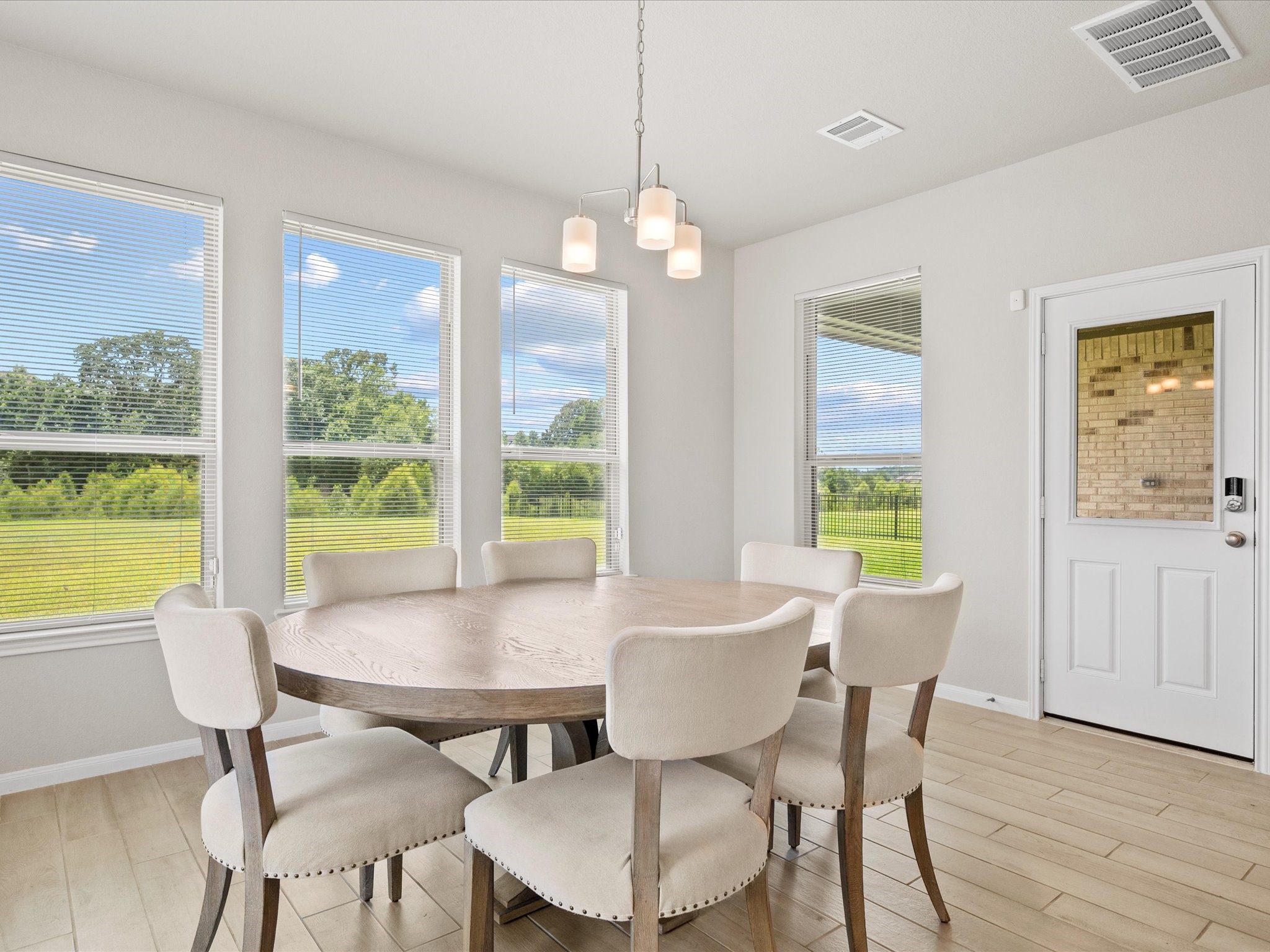 262 Peninsula Point Drive Montgomery, TX 77356 - Photo 11 of 45 a view of a dining room with furniture a chandelier and wooden floor