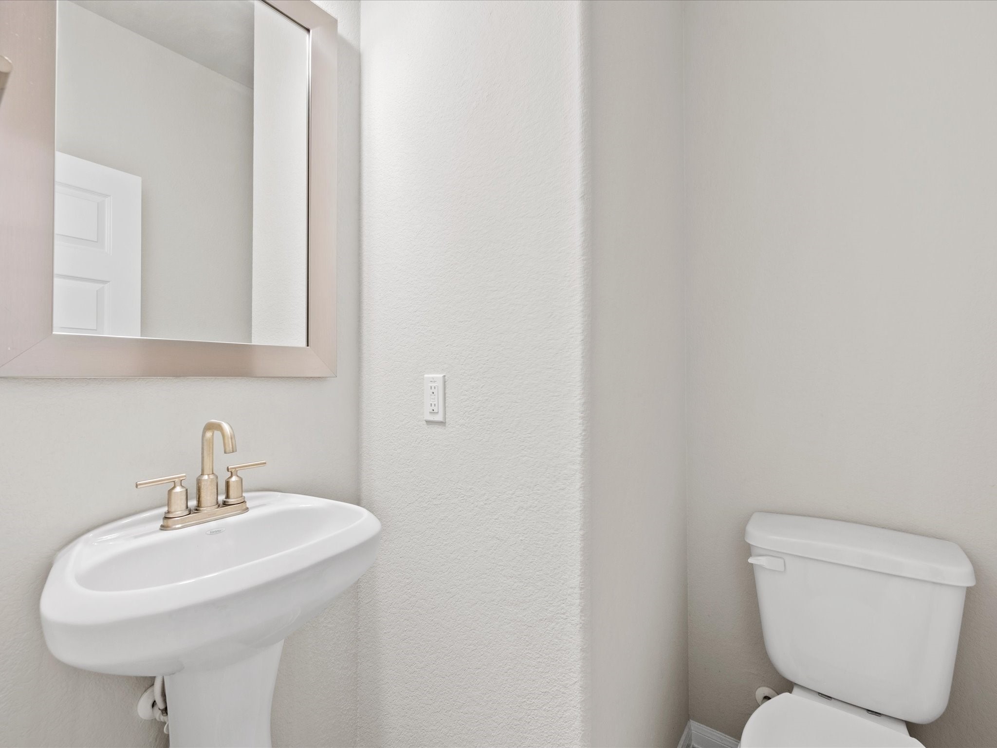 262 Peninsula Point Drive Montgomery, TX 77356 - Photo 19 of 45 a bathroom with a toilet sink and mirror