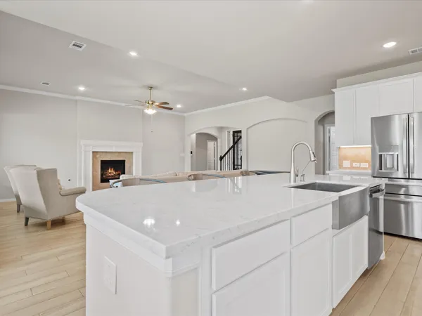 a bed sitting in a spacious bedroom next to a window
