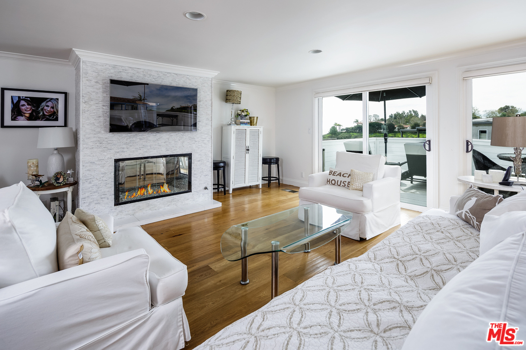 248 Paradise Cove Road Malibu, CA 90265 - Photo 2 of 35 a living room with fireplace furniture and a flat screen tv