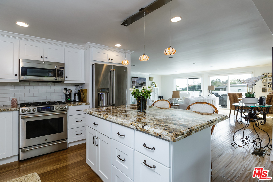 248 Paradise Cove Road Malibu, CA 90265 - Photo 13 of 35 a kitchen with kitchen island granite countertop a stove and a sink