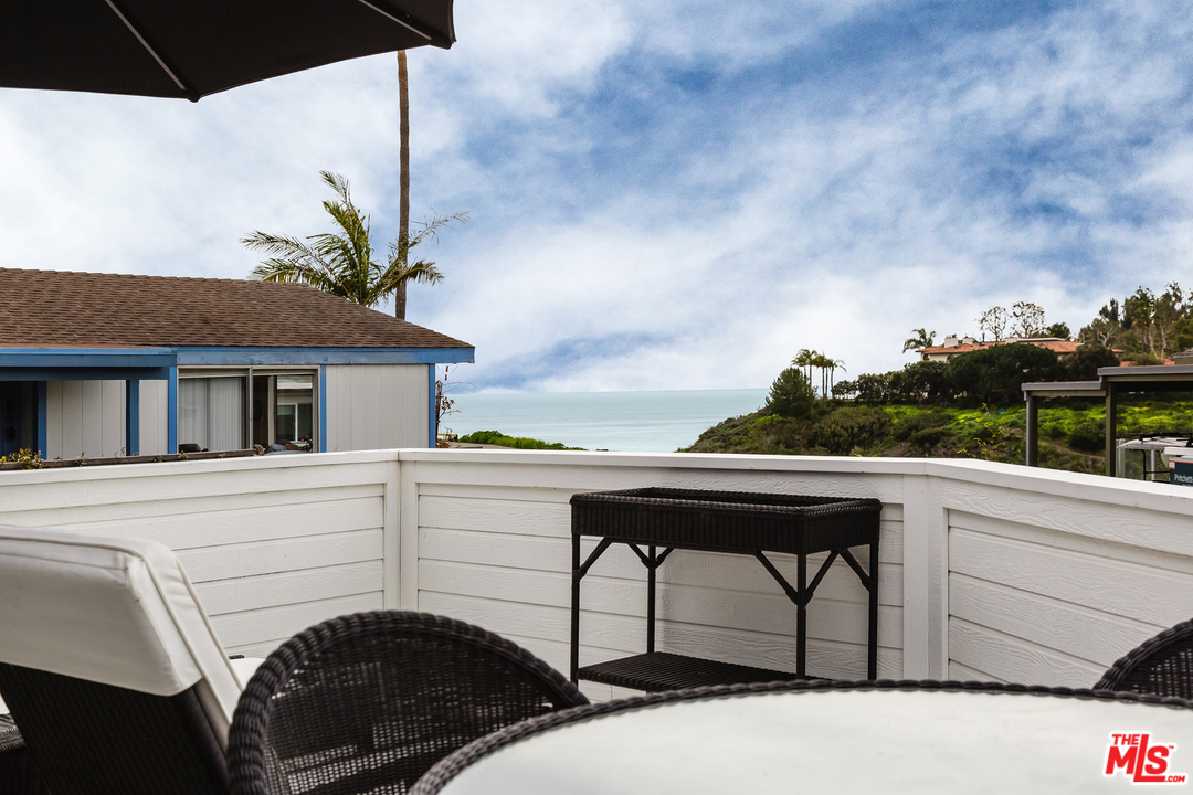 248 Paradise Cove Road Malibu, CA 90265 - Photo 22 of 35 a balcony with table and chairs