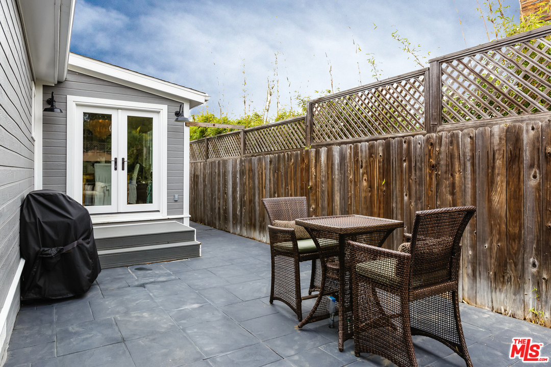 248 Paradise Cove Road Malibu, CA 90265 - Photo 28 of 35 a view of a chairs and table in the back yard of the house
