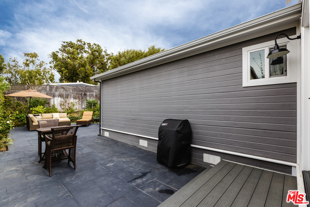 248 Paradise Cove Road Malibu, CA 90265 - Photo 29 of 35 a backyard of a house with table and chairs