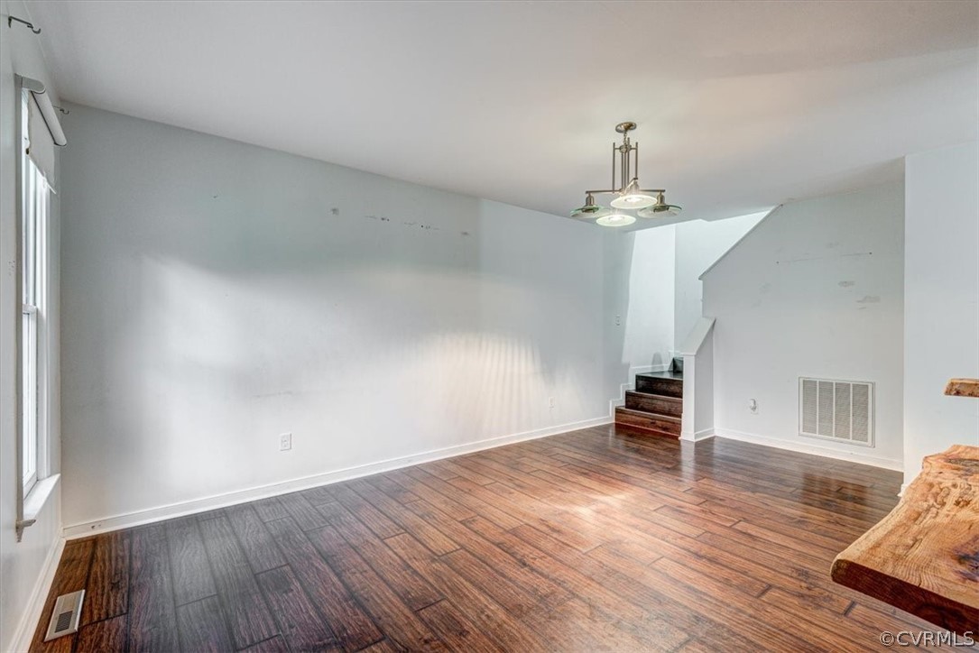 3909 Echo Ridge Place Midlothian, VA 23112 - Photo 3 of 14 an empty room with wooden floor chandelier and windows
