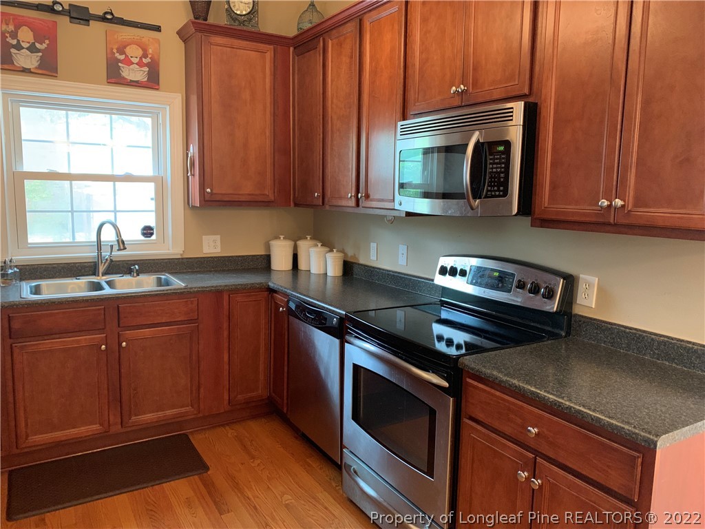 3629 Drayton Road Fayetteville, NC 28303 - Photo 12 of 31 a kitchen with sink cabinets and stainless steel appliances