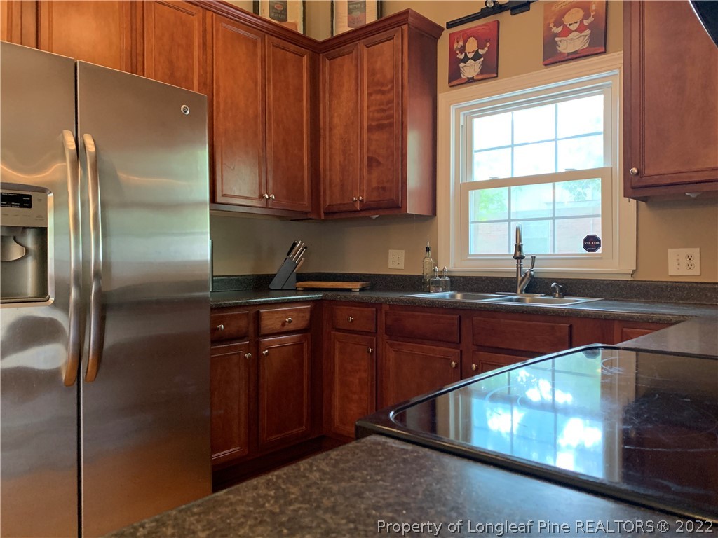 3629 Drayton Road Fayetteville, NC 28303 - Photo 13 of 31 a kitchen with stainless steel appliances granite countertop a refrigerator and a sink