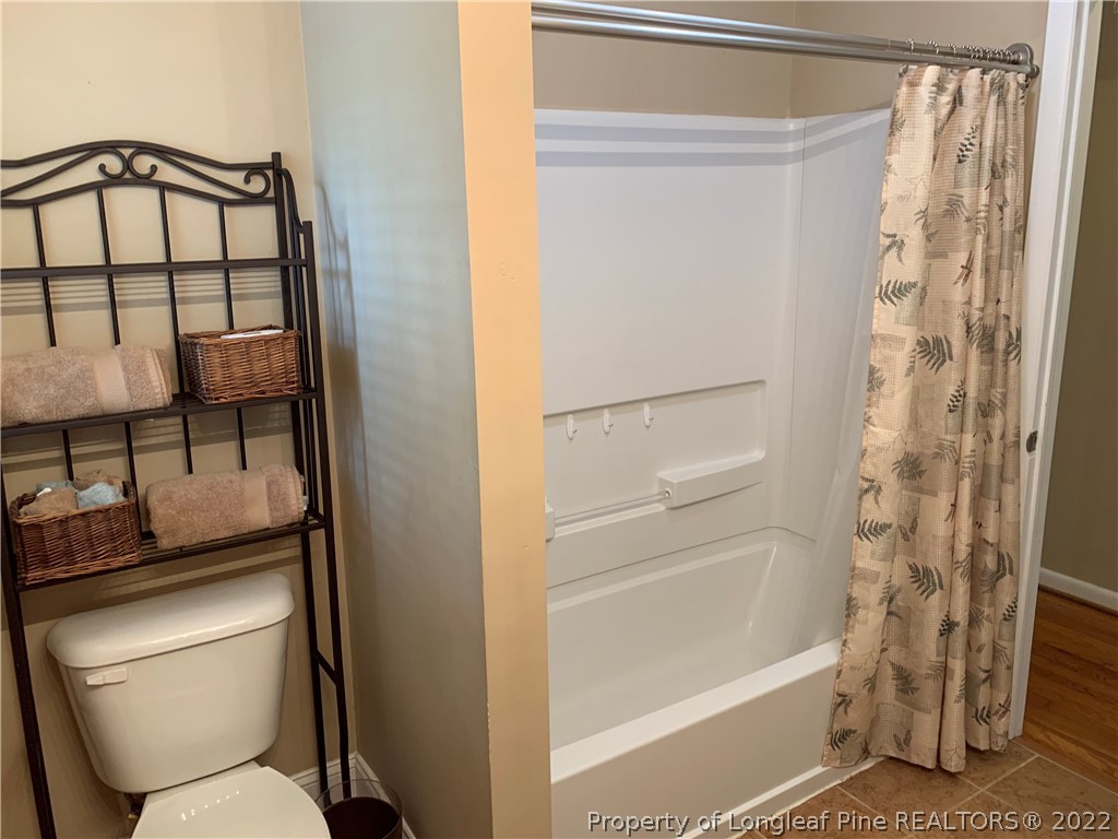 3629 Drayton Road Fayetteville, NC 28303 - Photo 20 of 31 a bathroom with a toilet and a shower