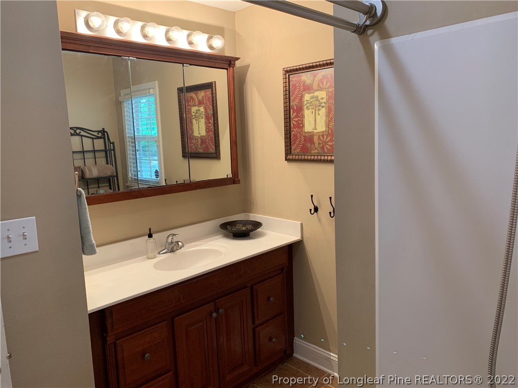 3629 Drayton Road Fayetteville, NC 28303 - Photo 21 of 31 a bathroom with a sink vanity and mirror