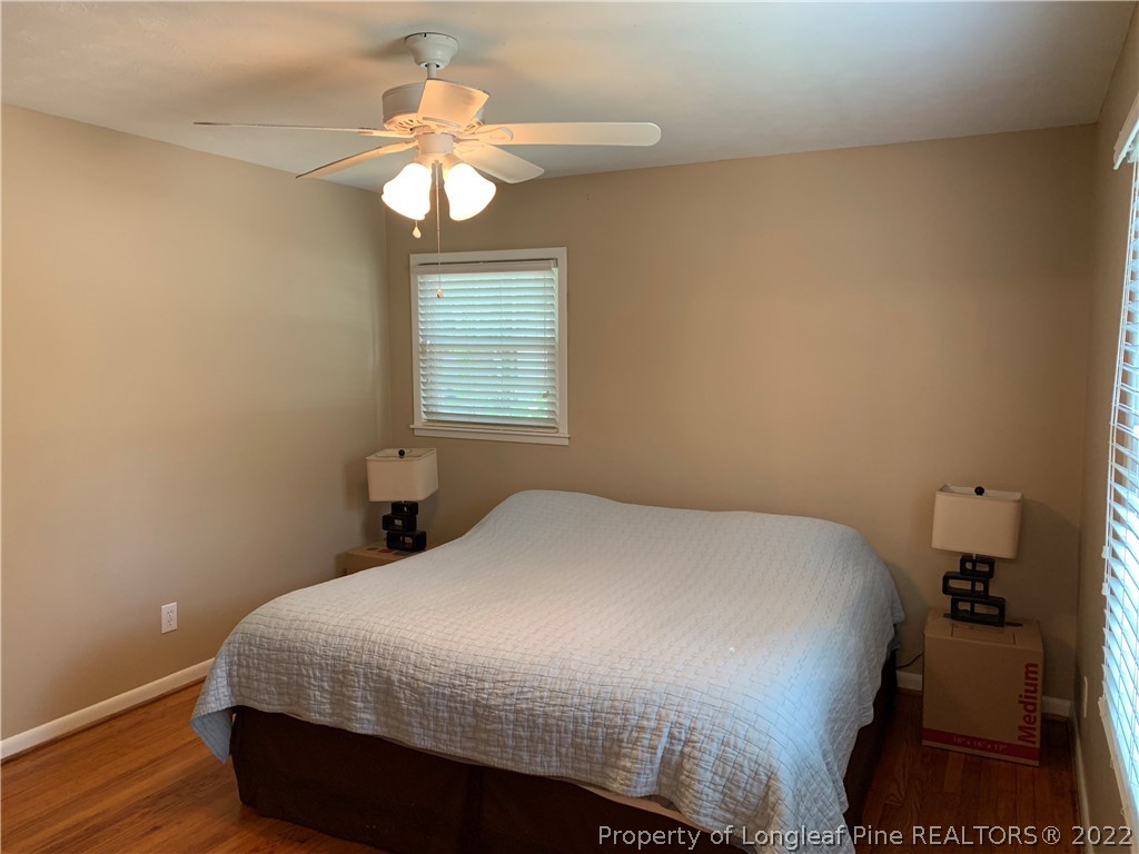 3629 Drayton Road Fayetteville, NC 28303 - Photo 23 of 31 a bedroom with a bed and a chandelier
