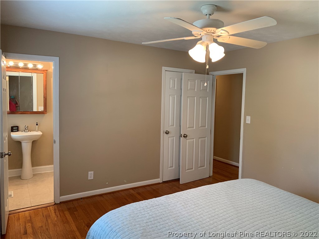 3629 Drayton Road Fayetteville, NC 28303 - Photo 24 of 31 a bedroom with a bed and a chandelier
