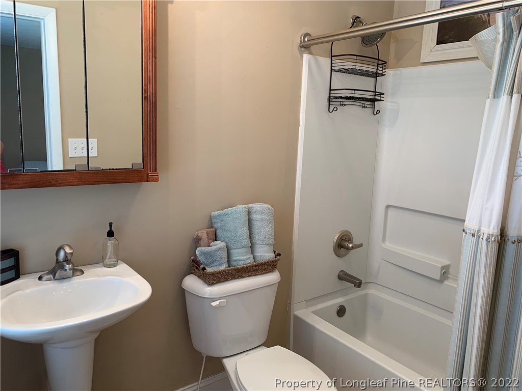 3629 Drayton Road Fayetteville, NC 28303 - Photo 25 of 31 a bathroom with a sink toilet and shower