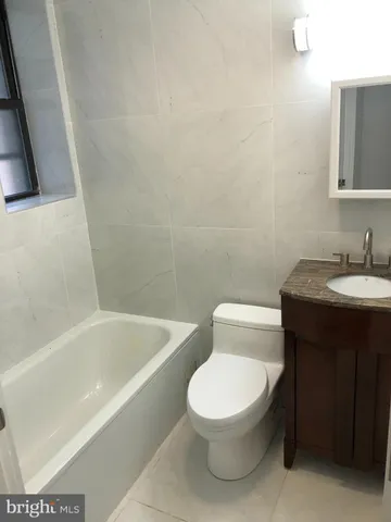 a white toilet sitting next to a bathroom sink