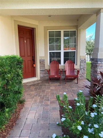 a view of a house with chairs in front of door