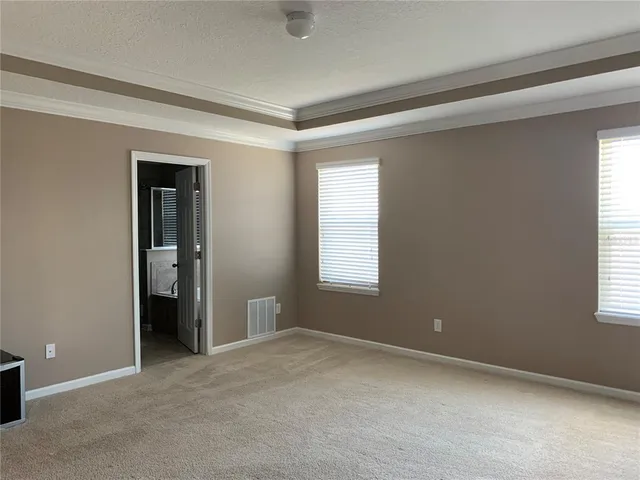 a spacious bathroom with a mirror and a shower