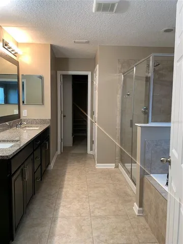 a bathroom with a bathtub and shower