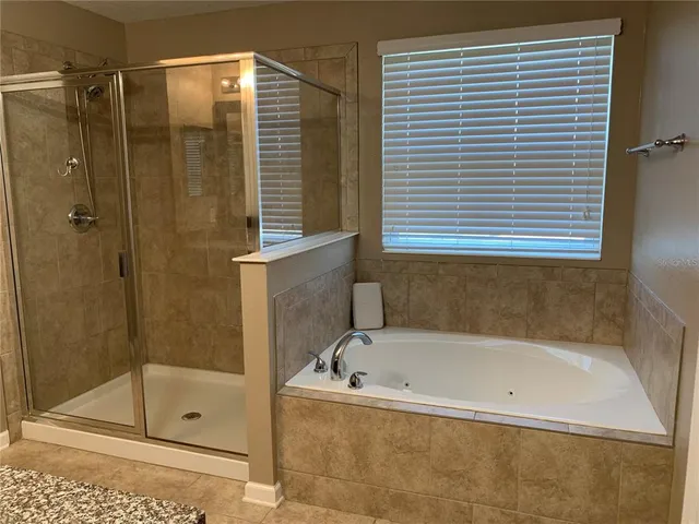 a bathroom with a granite countertop sink double and mirror