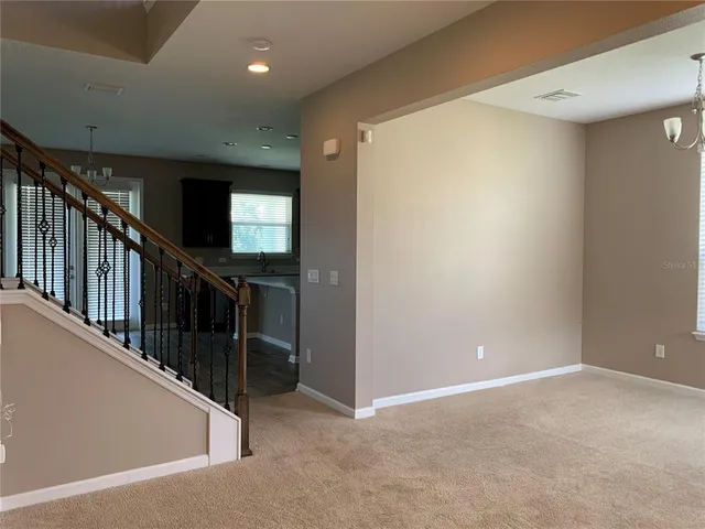 a large kitchen with stainless steel appliances granite countertop a refrigerator and a sink