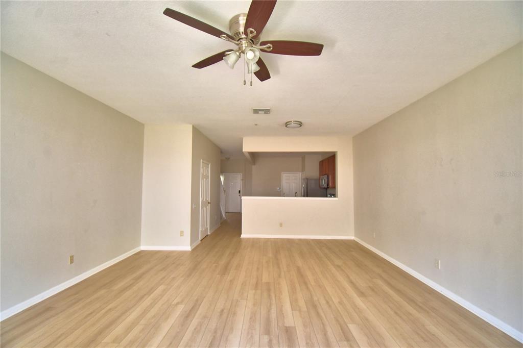 3151 Sinclair Street, Unit 104 Orlando, FL 32835 - Photo 12 of 64 wooden floor in an empty room with a window