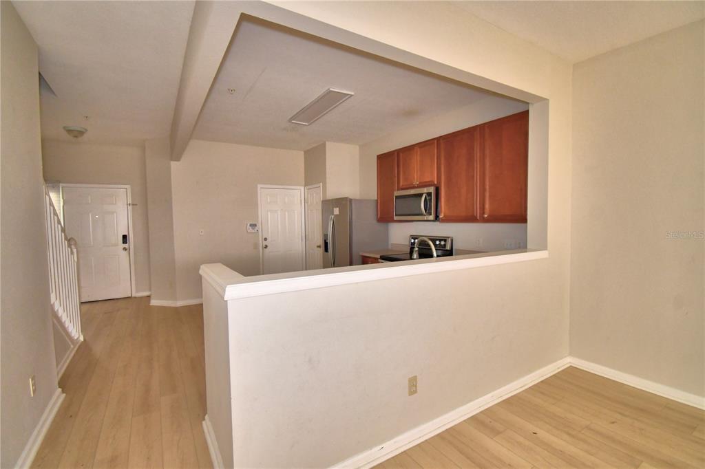 3151 Sinclair Street, Unit 104 Orlando, FL 32835 - Photo 17 of 64 a view of kitchen with stainless steel appliances a refrigerator and a microwave