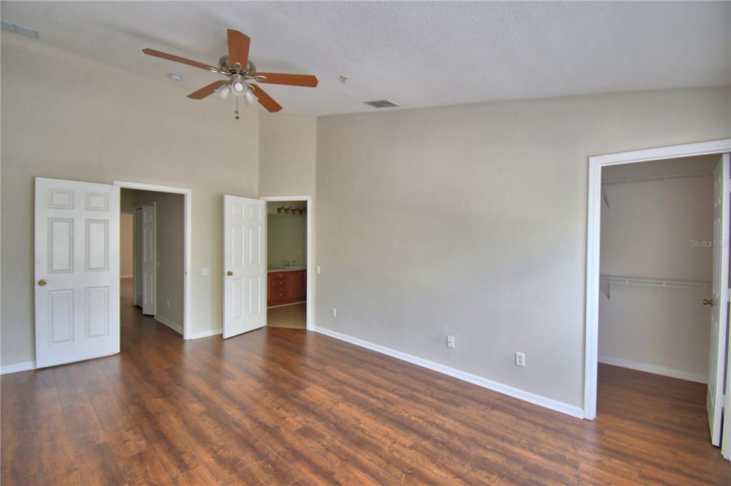 3151 Sinclair Street, Unit 104 Orlando, FL 32835 - Photo 23 of 64 a view of a room with wooden floor and ceiling fan