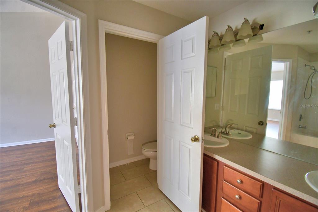 3151 Sinclair Street, Unit 104 Orlando, FL 32835 - Photo 28 of 64 a bathroom with a sink a toilet and shower