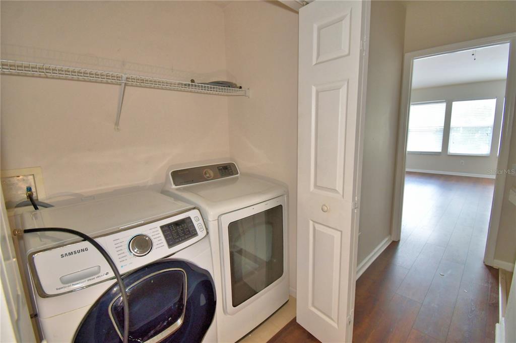 3151 Sinclair Street, Unit 104 Orlando, FL 32835 - Photo 31 of 64 a utility room with dryer and washer