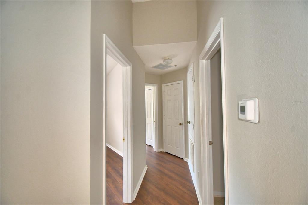 3151 Sinclair Street, Unit 104 Orlando, FL 32835 - Photo 33 of 64 a view of a hallway with wooden floor