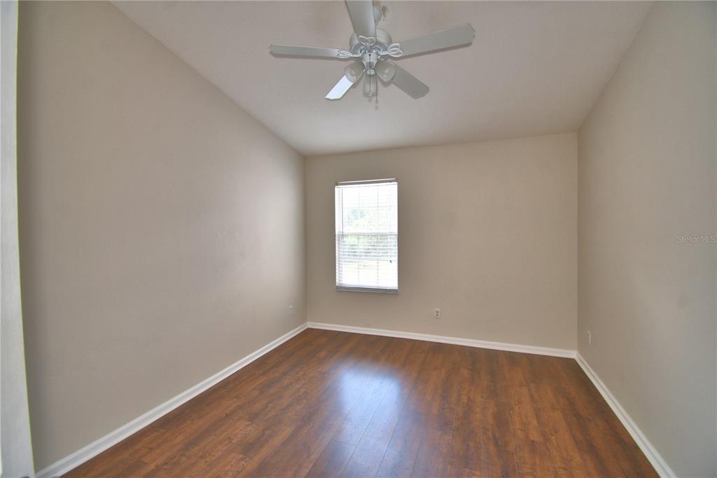 3151 Sinclair Street, Unit 104 Orlando, FL 32835 - Photo 34 of 64 an empty room with wooden floor and windows