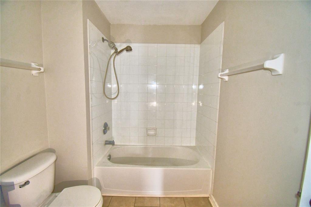 3151 Sinclair Street, Unit 104 Orlando, FL 32835 - Photo 38 of 64 a bathroom with a shower and a toilet