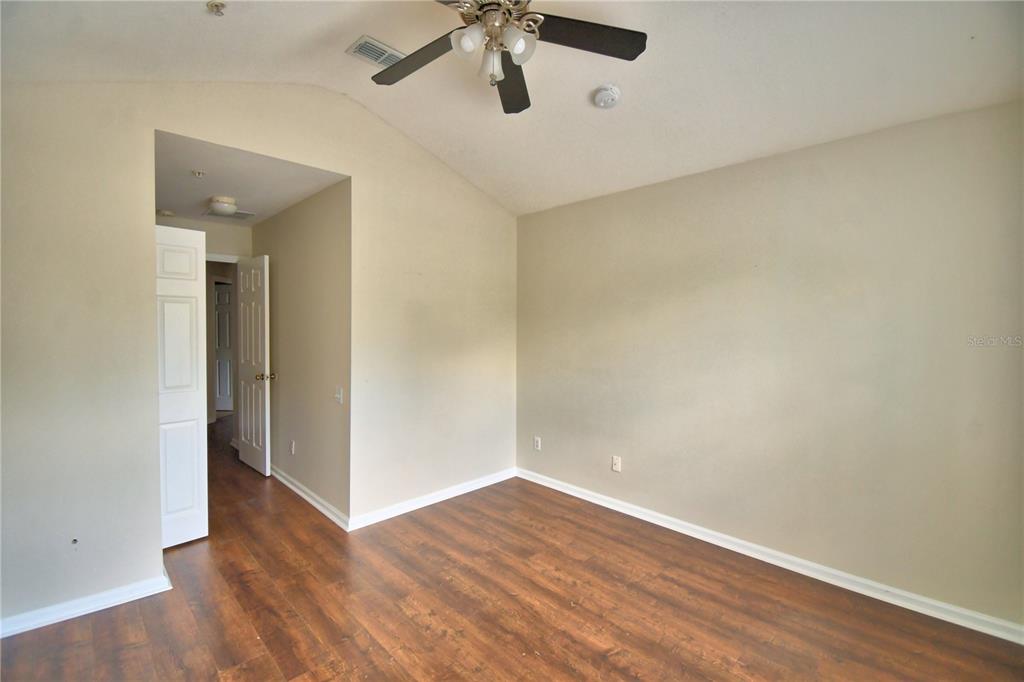 3151 Sinclair Street, Unit 104 Orlando, FL 32835 - Photo 43 of 64 a view of an empty room with wooden floor
