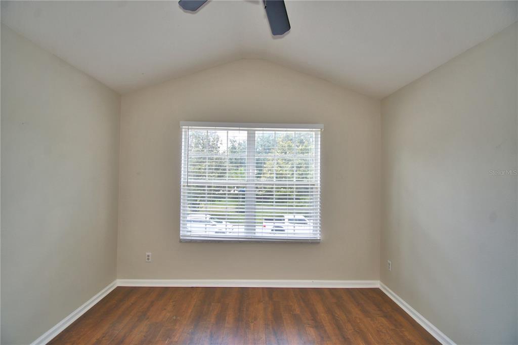 3151 Sinclair Street, Unit 104 Orlando, FL 32835 - Photo 45 of 64 a view of an empty room with wooden floor and a window
