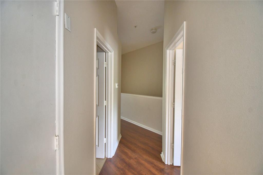 3151 Sinclair Street, Unit 104 Orlando, FL 32835 - Photo 47 of 64 a view of a hallway with wooden floor