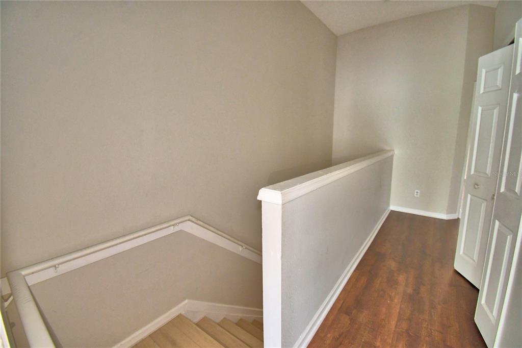 3151 Sinclair Street, Unit 104 Orlando, FL 32835 - Photo 48 of 64 a view of an empty room with wooden floor